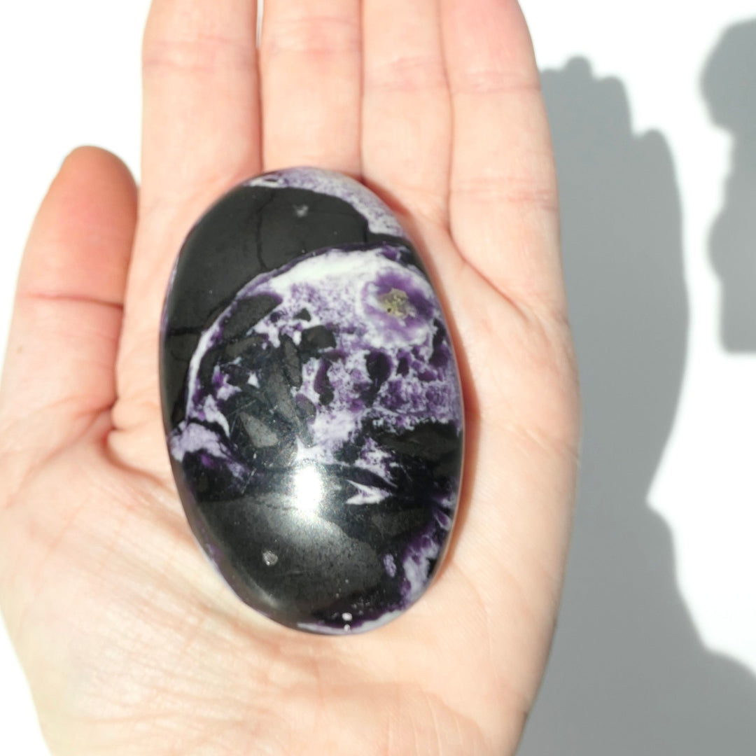 Lepidolite Palm Stone in a hand